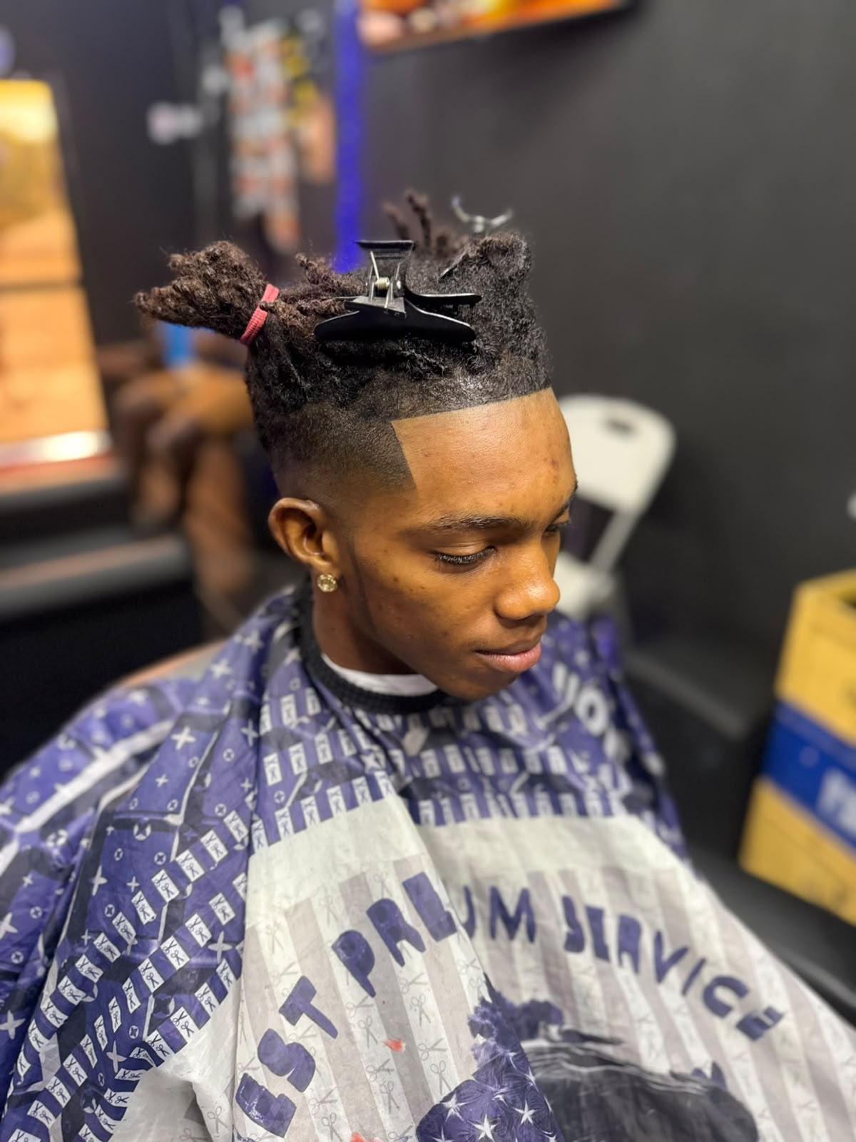 High top haircut with sharp lineup in the barber chair