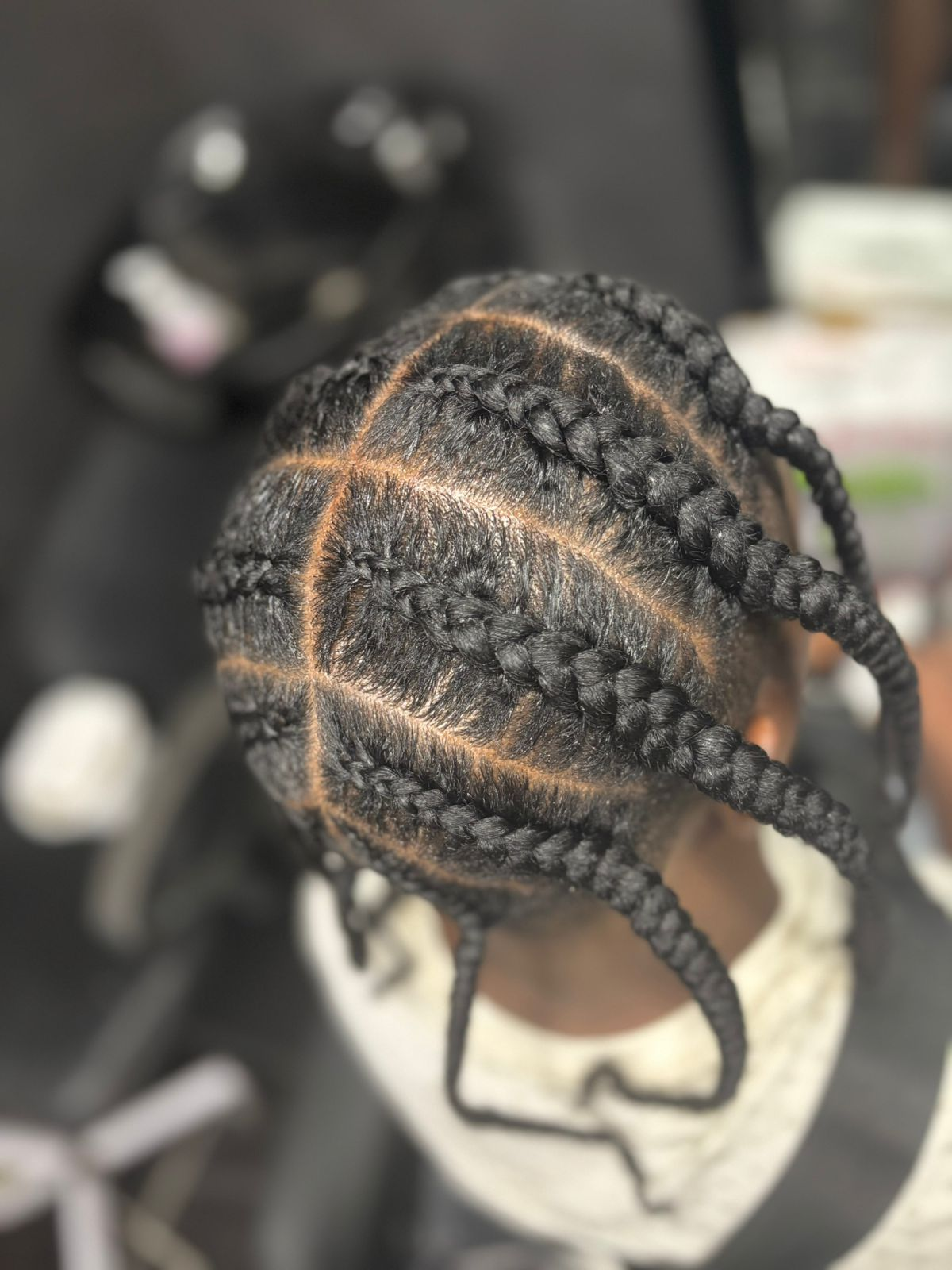 Top view of clean curved cornrow pattern with crisp parts